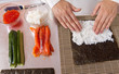 cook making   sushi rolls