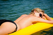 Details der Fotografie Summer woman sunbathe on water floating mattress