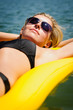 Details der Fotografie Summer woman relax on water floating mattress