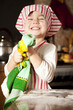 little chef in the kitchen wearing an apron and headscarf