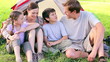 Happy family sitting on the grass