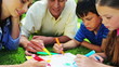 Happy children drawing with their parents