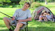 Smiling man fishing in front of his family