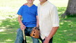 Smiling boy holding a baseball bat and a glove