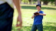 Happy boy catching a baseball while wearing a glove