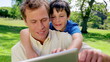Happy father and son using a tablet computer