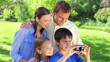 Smiling boy holding a digital camera