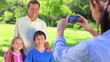 Smiling father standing with his children