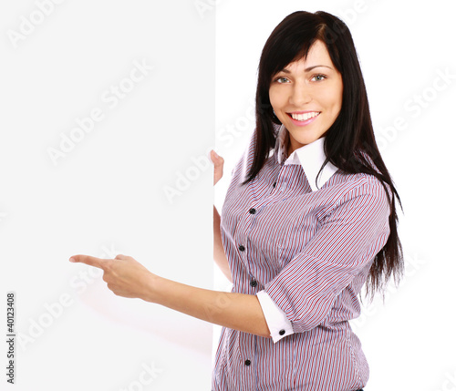 Photo: Portrait of a happy teenage girl showing an empty billboard Portrait of a happy teenage girl showing an empty billboard