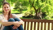 Video: Woman sitting on a bench Woman sitting on a bench