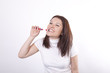 Young beautiful woman cleaning her teeth