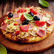 Pizza with ham, mushrooms and cherry tomatoes