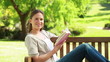 Video: A woman holding a book while sitting on a bench A woman holding a book while sitting on a bench