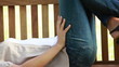 Video: Woman lying on a bench wearing headphone Woman lying on a bench wearing headphone