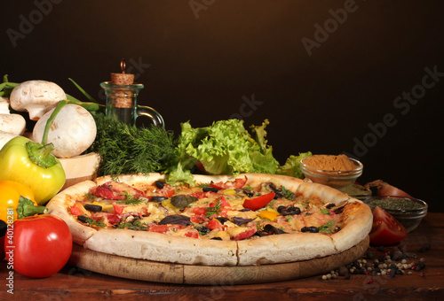 Photo: delicious pizza, vegetables and spices delicious pizza, vegetables and spices