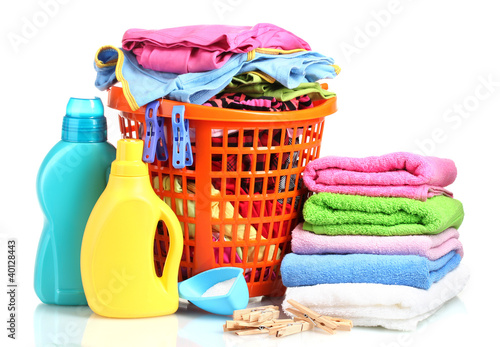 Photo: Clothes with detergent and washing powder in orange plastic Clothes with detergent and washing powder in orange plastic