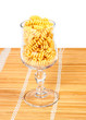 Macaroni in a glass on straw mat