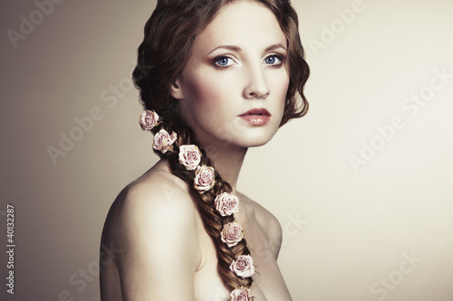 Photo: Portrait of a beautiful woman with flowers in her hair Portrait of a beautiful woman with flowers in her hair