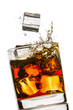 Splash in a glass of whiskey on white background