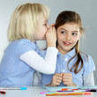 Two cute girlfriends learning together at school