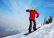 Snowboarder jumping through air with  blue sky in background
