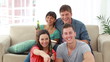 Video: Smiling friends looking at the television while laughing Smiling friends looking at the television while laughing