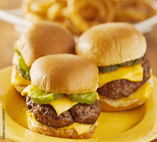 Photo: three burger sliders with cheese and pickle three burger sliders with cheese and pickle
