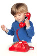 Photo: Beautiful baby with a red phone Beautiful baby with a red phone