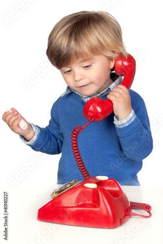 Photo: Beautiful baby with a red phone Beautiful baby with a red phone