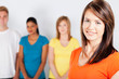 young woman standing in front of group of people
