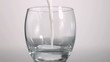 Milk flowing in super slow motion in a glass