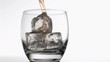 Whiskey poured in super slow motion in a glass with ice cubes