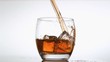 Amber alcohol poured in super slow motion