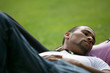 Young man lying in the grass with his girlfriend
