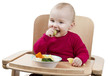Foto: young child eating in high chair young child eating in high chair