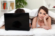 Photo: Bored woman next to boyfriend in bed Bored woman next to boyfriend in bed