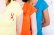 group of young people with red ribbon on their chest