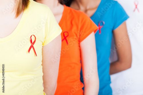 Photo: group of young people with red ribbon on their chest group of young people with red ribbon on their chest