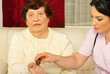Nurse giving medicines to elderly woman