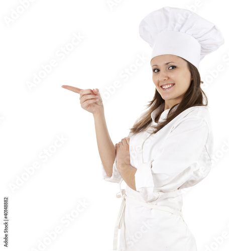 Photo: chef woman in white uniform and hat pointing in side chef woman in white uniform and hat pointing in side