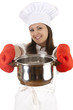 female cook in uniform and hat  keeping steel pot