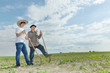 Farmer with an apprentice in the field