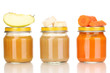 Jars of baby puree with spoon isolated on white