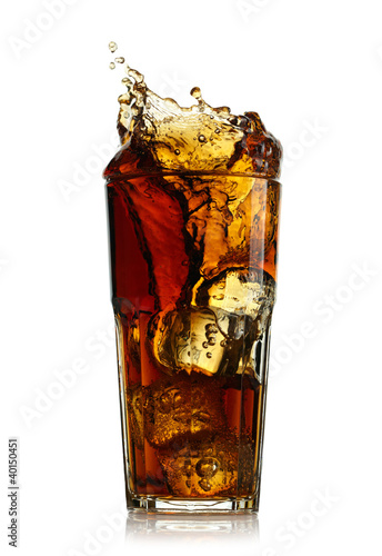 Photo: Splashing cola in glass. Isolated on white background Splashing cola in glass. Isolated on white background