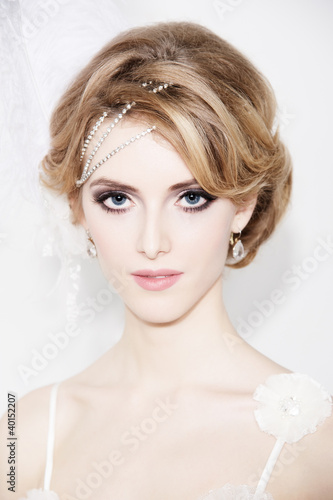 Photo: Portrait of young beautiful bride over white background Portrait of young beautiful bride over white background