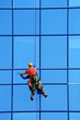 Washer wash the windows of modern skyscraper