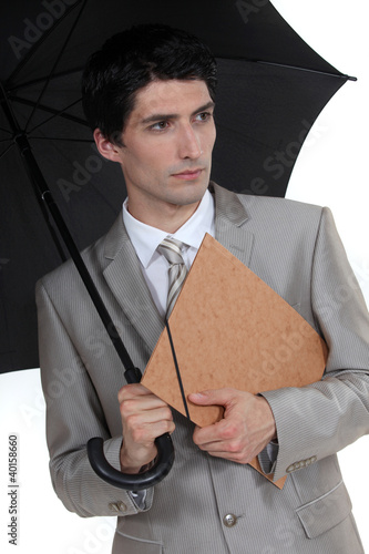 Foto: Man with umbrella and folder under his arm Man with umbrella and folder under his arm