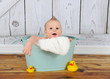 sweet baby boy playing in washtub
