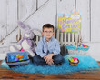 handsome young boy sitting in Easter scene