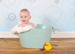 handsome baby boy sitting in washtub